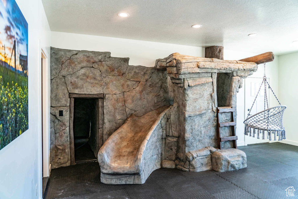Living area featuring a textured ceiling and recessed lighting
