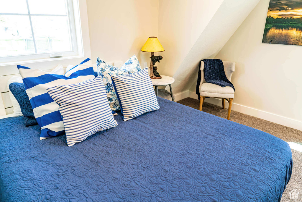 Carpeted bedroom featuring baseboards