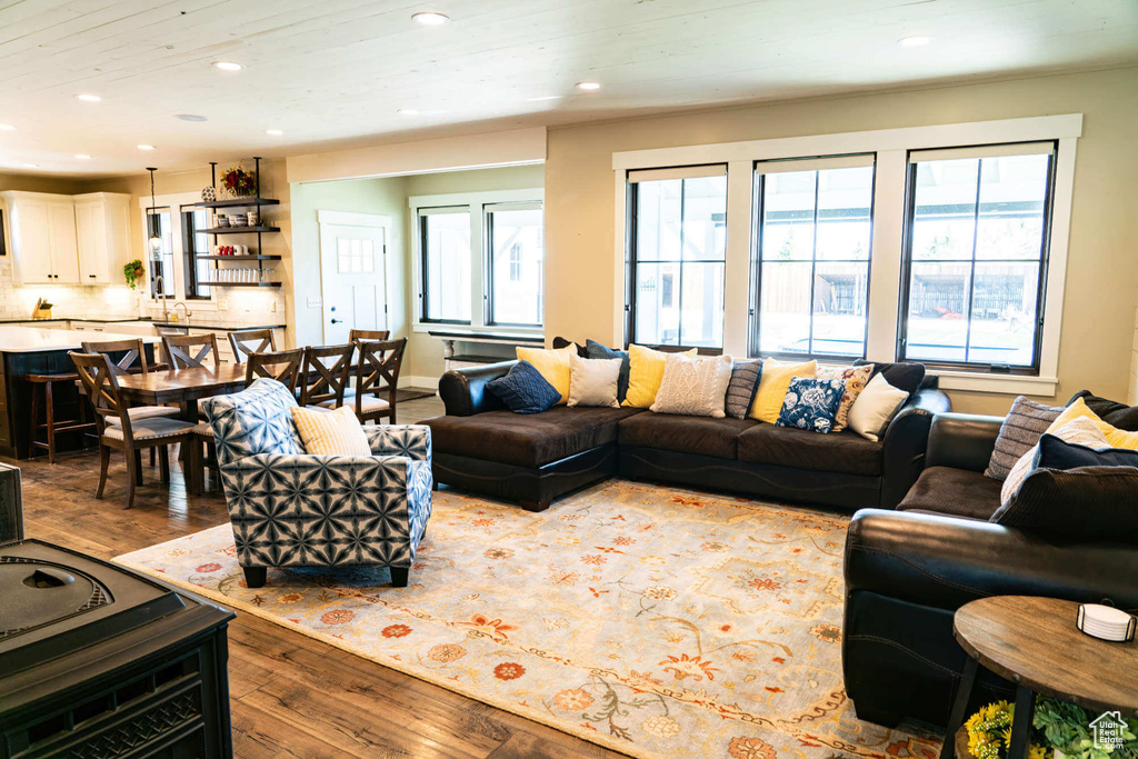 Living room with wood-type flooring, healthy amount of natural light, and recessed lighting