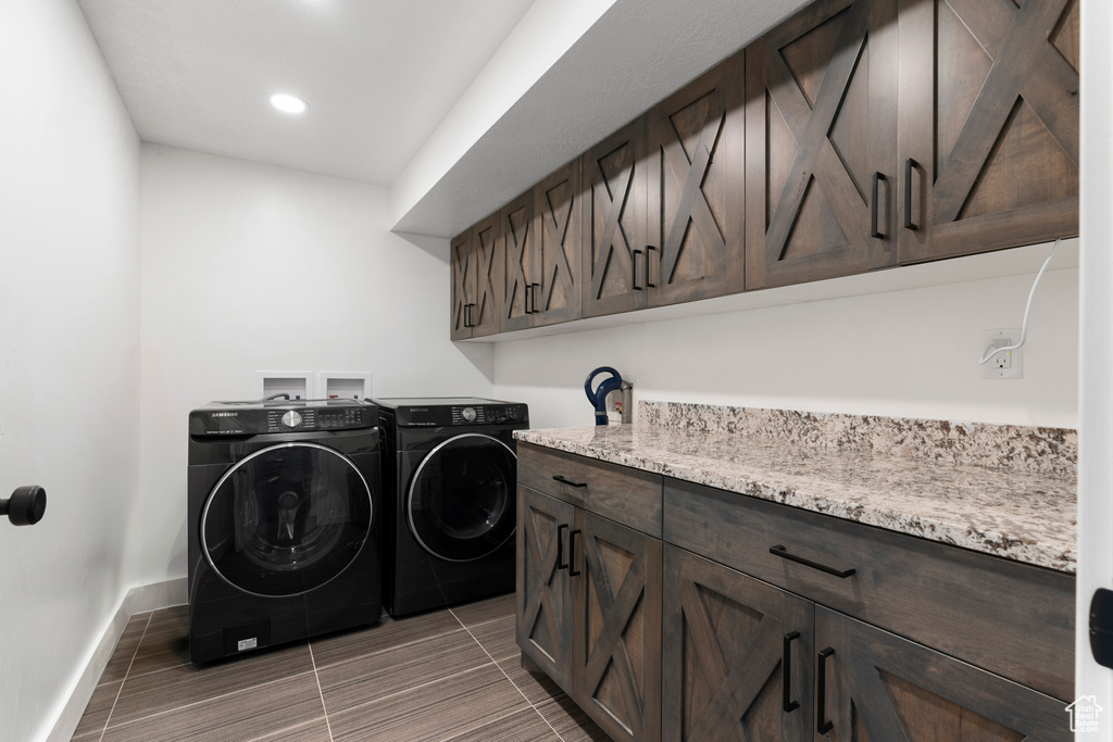Laundry area with washer and clothes dryer, cabinet space, baseboards, and recessed lighting
