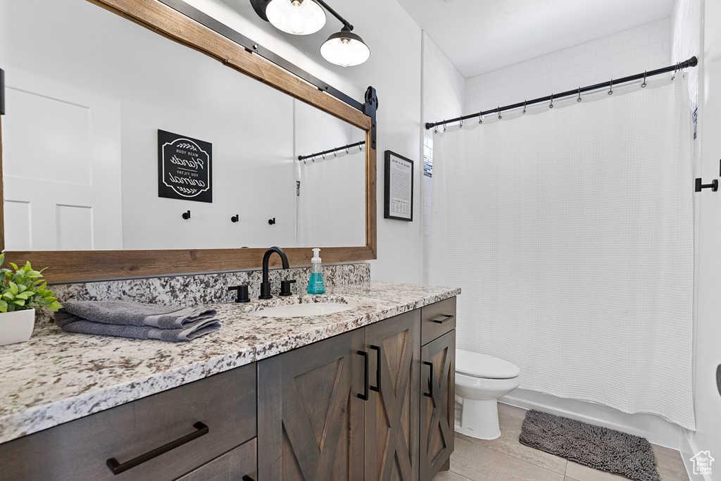 Full bath featuring vanity, toilet, and shower / bathtub combination with curtain