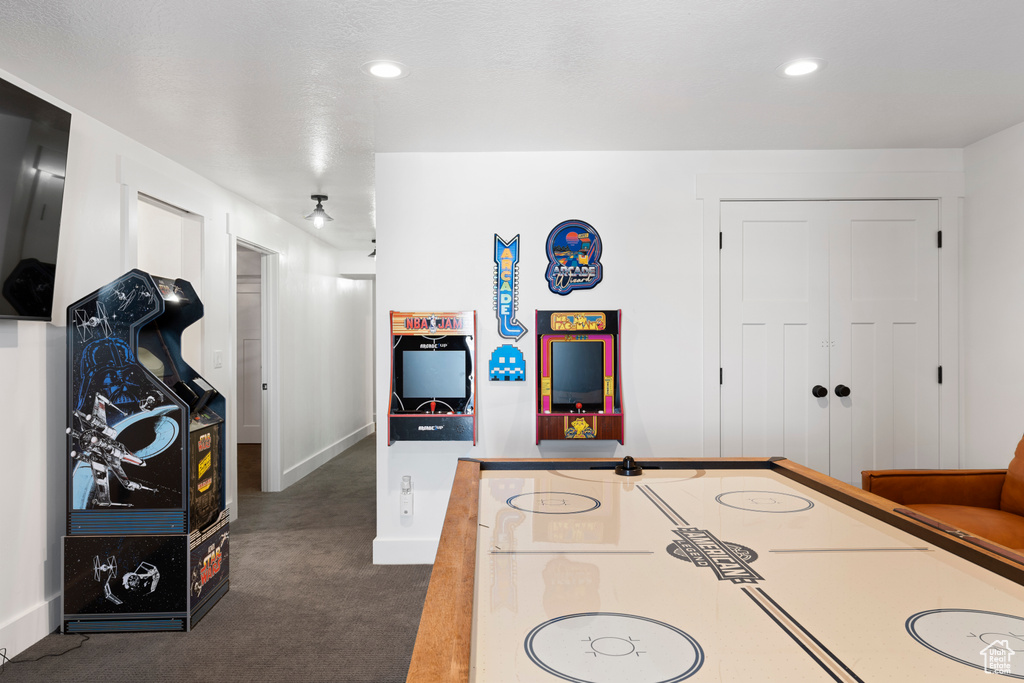 Playroom featuring dark colored carpet, baseboards, and recessed lighting