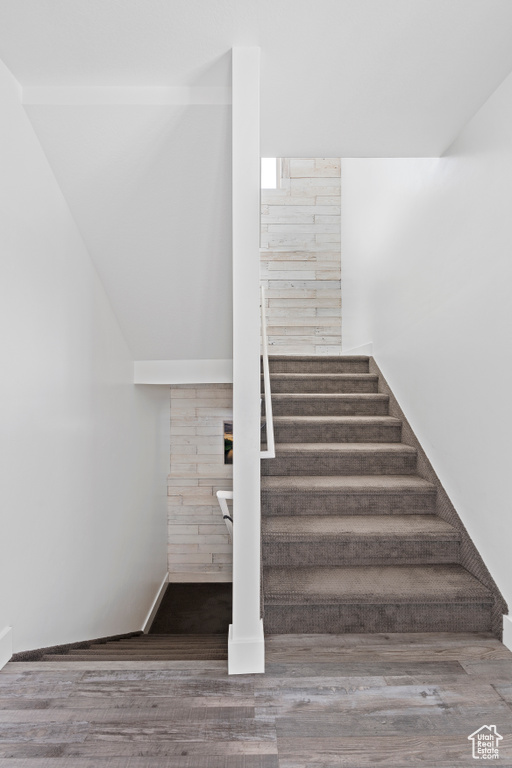Stairs featuring wood finished floors