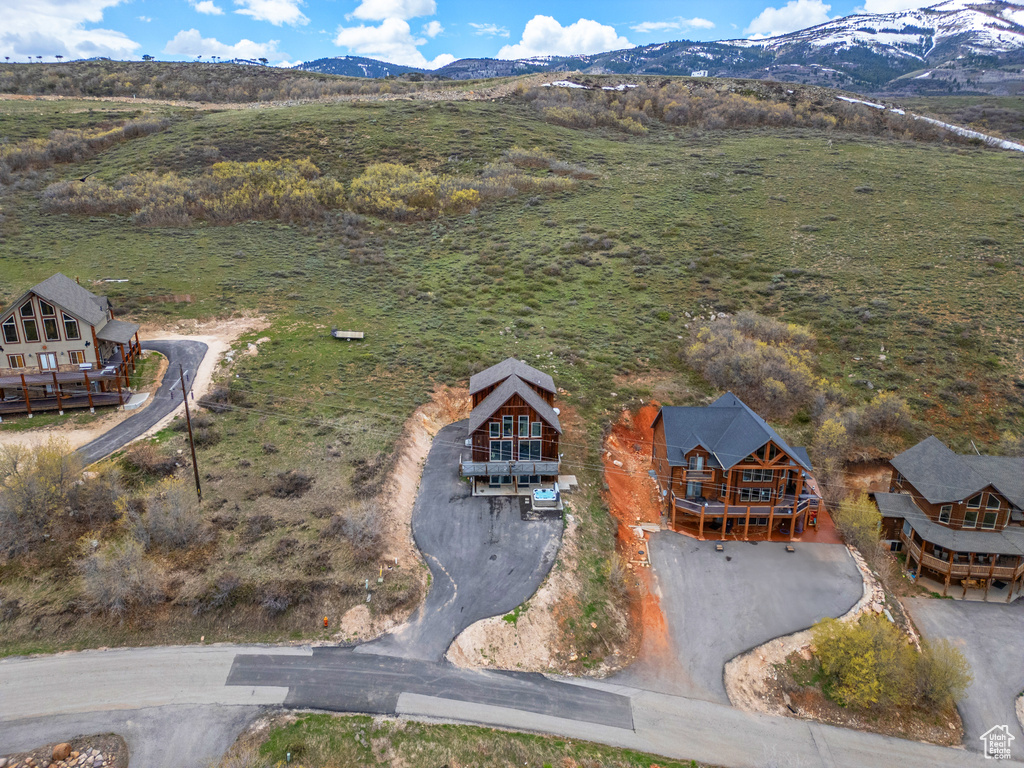 Aerial view of property and surrounding area with mountains