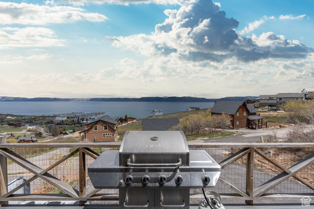 Balcony featuring a water view and grilling area