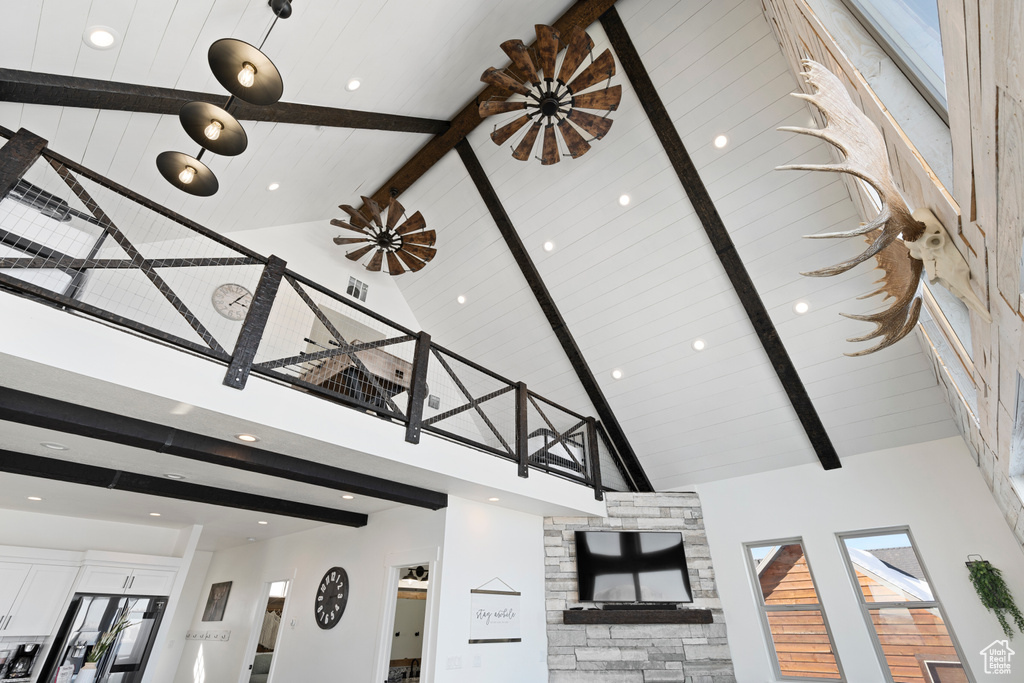 Unfurnished living room with high vaulted ceiling, beam ceiling, and recessed lighting