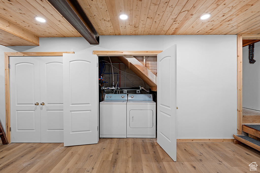 Laundry area featuring recessed lighting, separate washer and dryer, light wood-style flooring, wooden ceiling, and baseboards