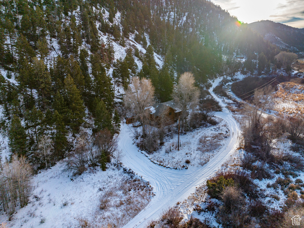 Snowy aerial view featuring a mountain view