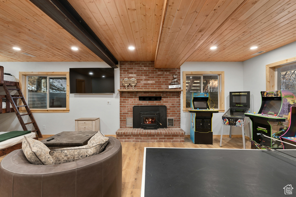 Living area with wood ceiling with exposed beams, wood finished floors, and recessed lighting