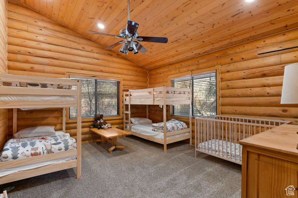Bedroom with wood ceiling, vaulted ceiling, rustic walls, carpet flooring, and recessed lighting