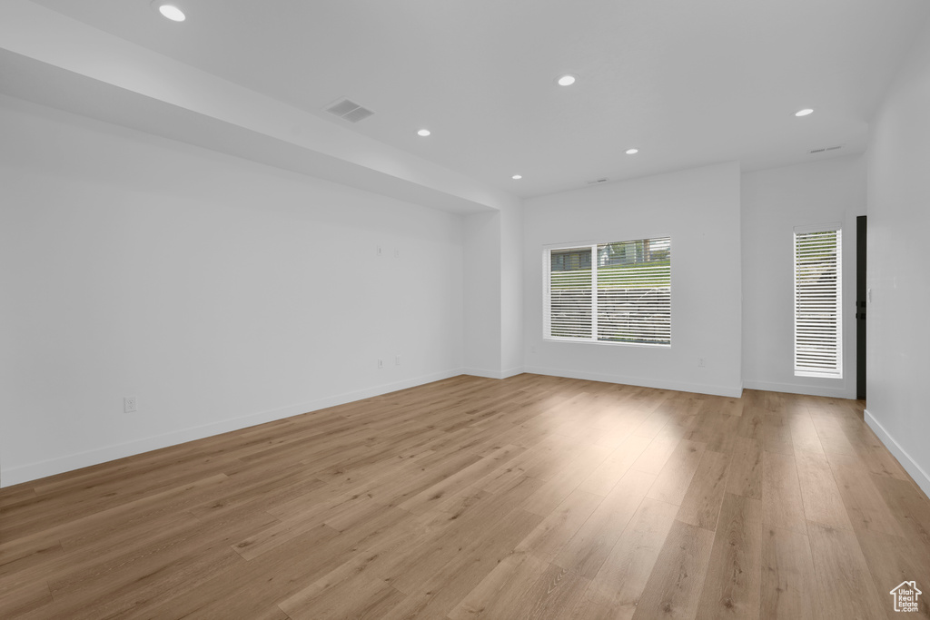 Empty room featuring recessed lighting, light wood finished floors, and baseboards