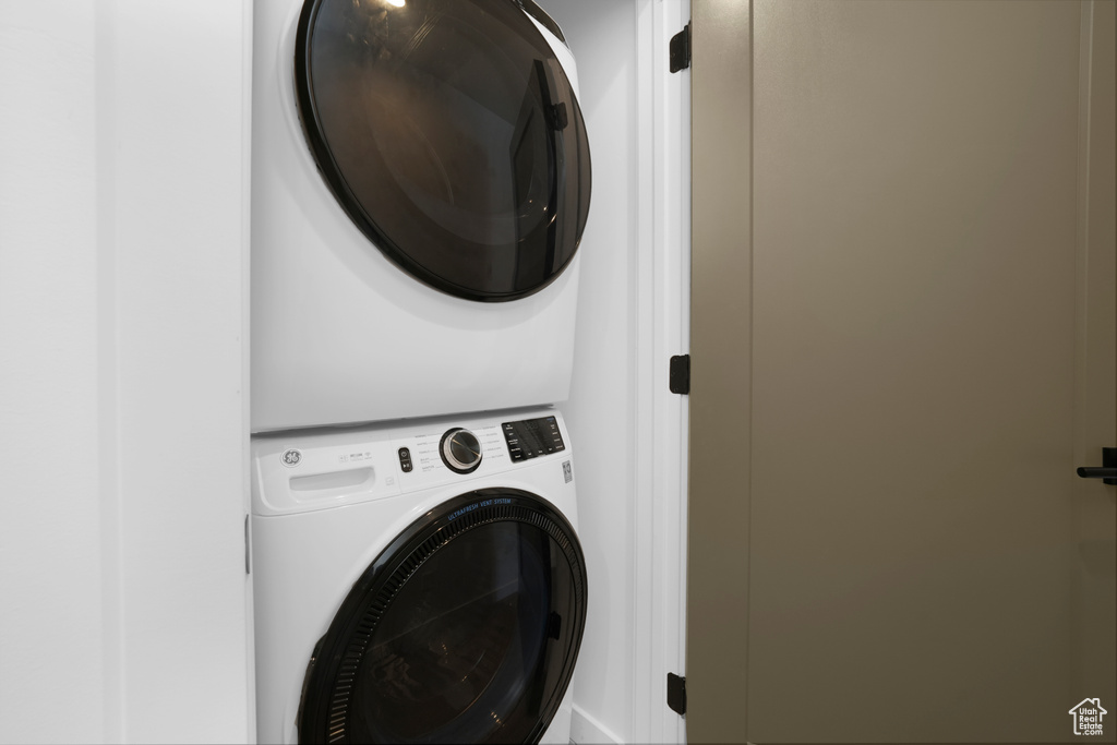 Laundry room featuring stacked washer / drying machine