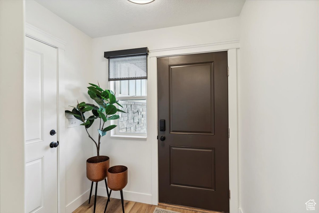 Entrance foyer featuring light wood-style flooring and baseboards