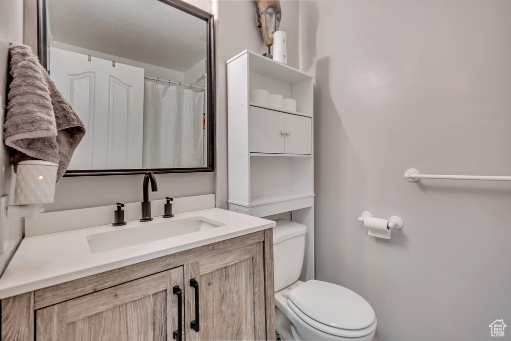 Full bath with toilet and vanity