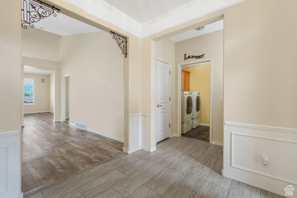 Hallway featuring washer and clothes dryer and wood finished floors