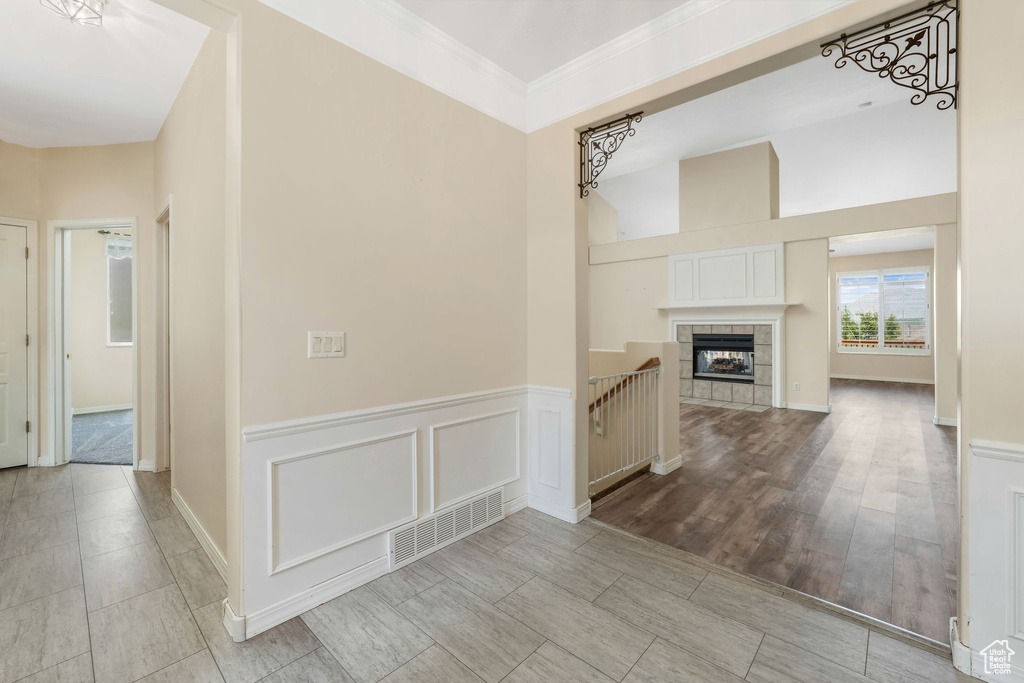 Hallway with a towering ceiling and crown molding