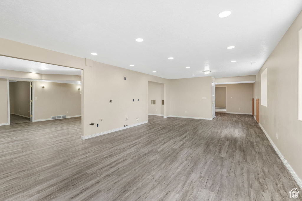 Unfurnished living room featuring recessed lighting, baseboards, and light wood finished floors
