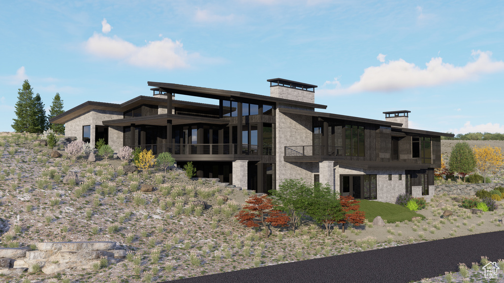 Back of property with a balcony