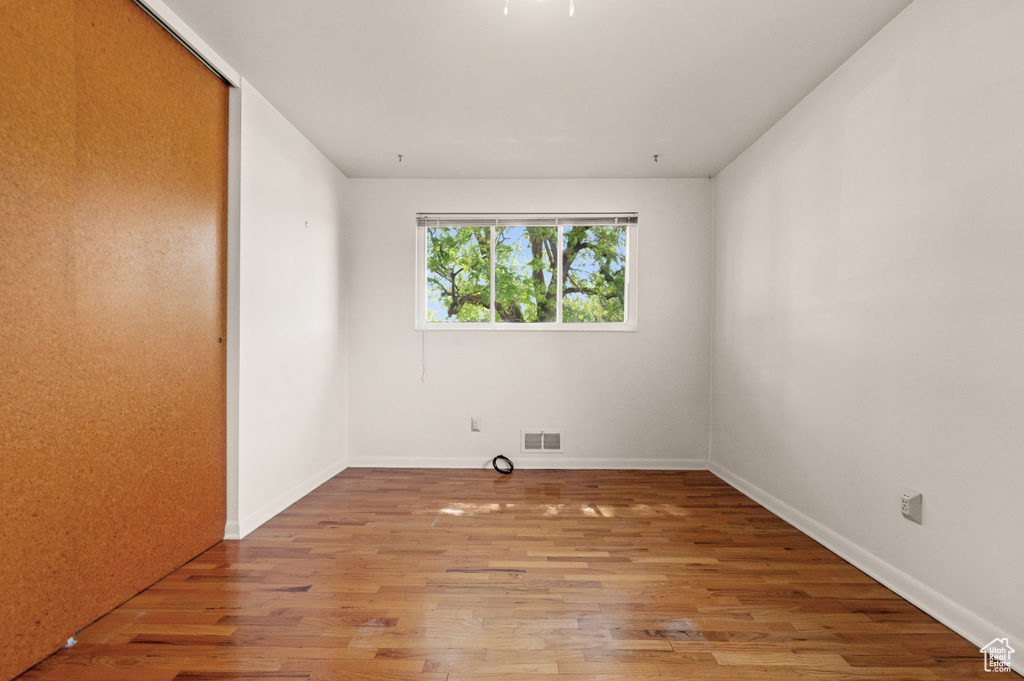 Spare room featuring wood finished floors and baseboards