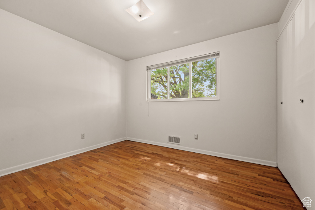 Unfurnished room with light wood-style floors and baseboards