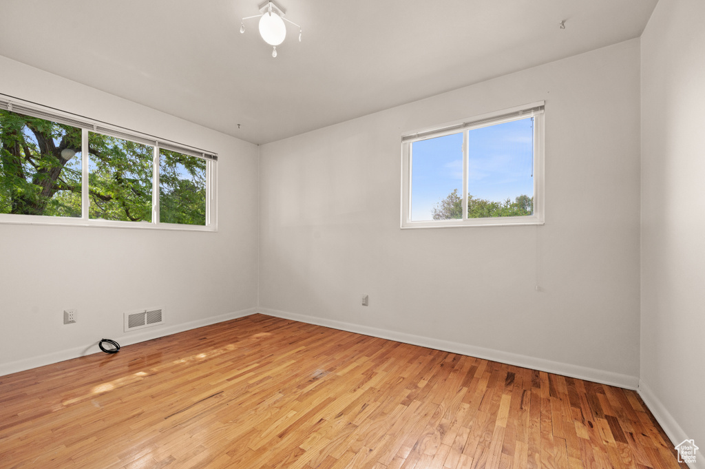 Empty room with light wood-type flooring and baseboards