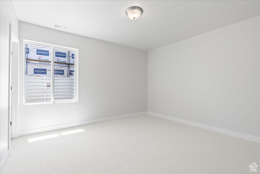 Unfurnished room featuring carpet flooring and baseboards