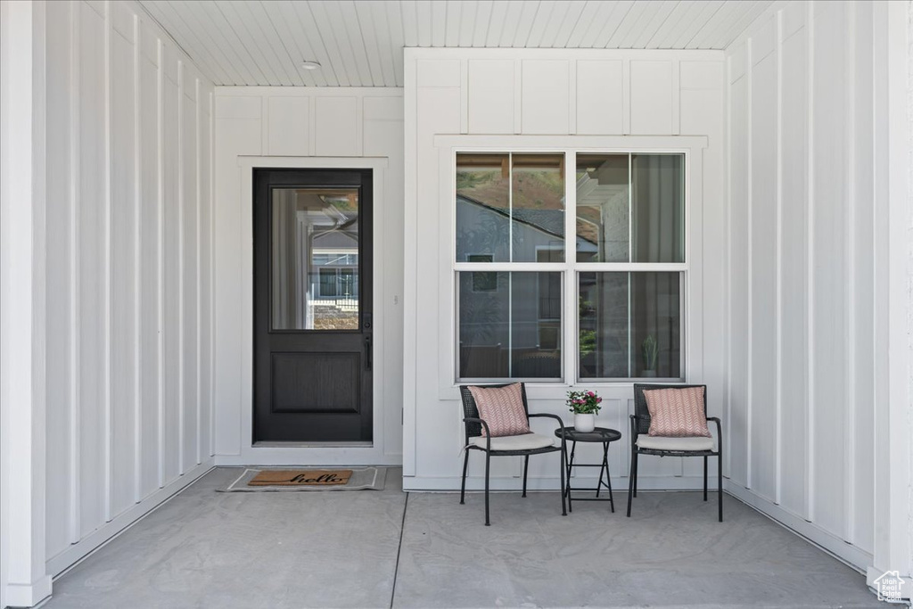 View of exterior entry featuring board and batten siding