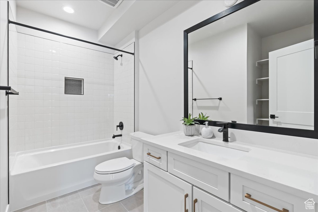 Bathroom featuring vanity, toilet, bathtub / shower combination, and tile patterned flooring