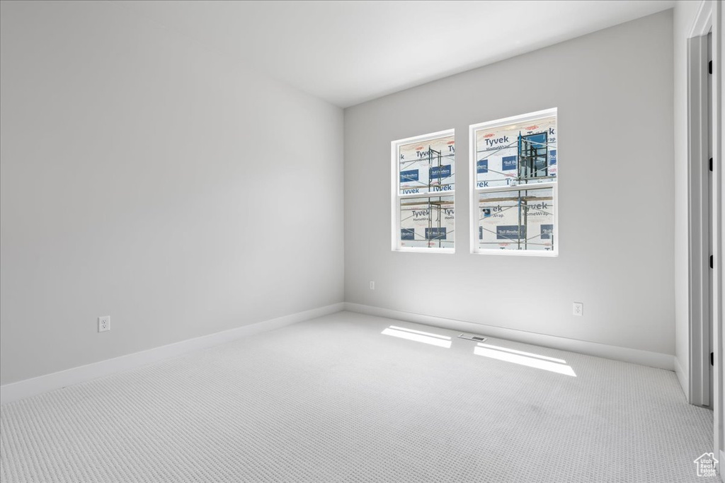 Unfurnished room with carpet floors and baseboards