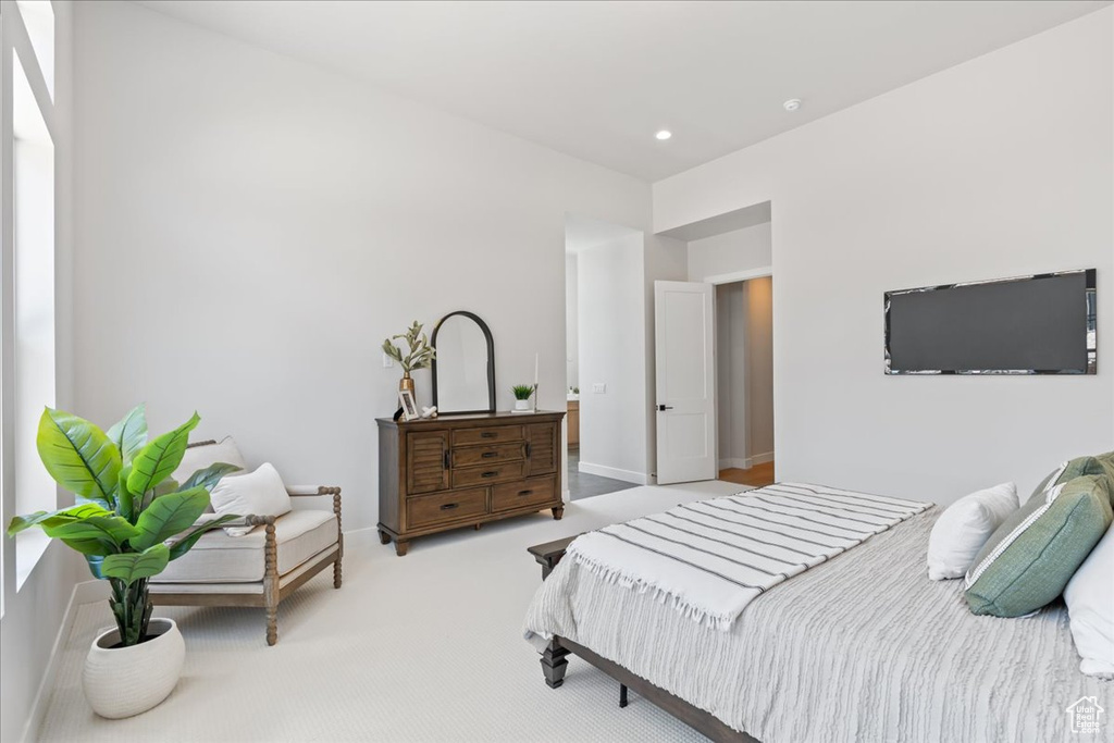 Carpeted bedroom with baseboards and recessed lighting