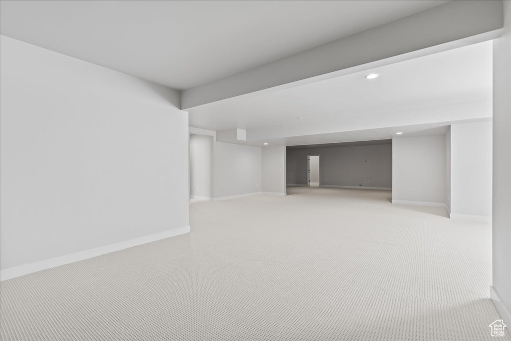 Finished below grade area featuring recessed lighting, baseboards, and light colored carpet