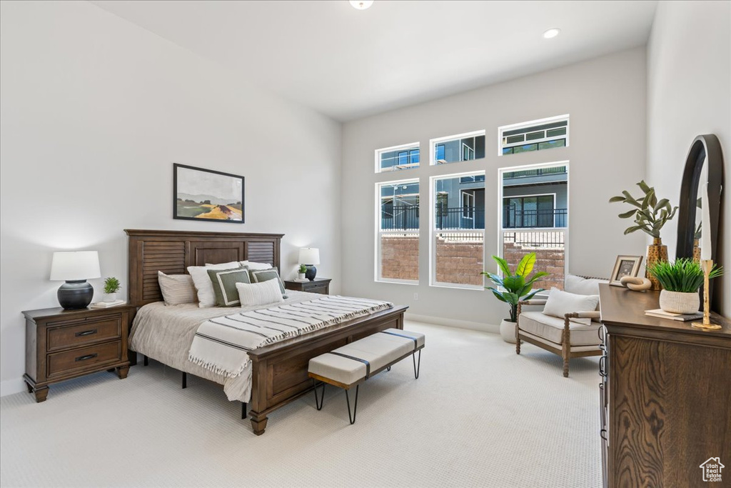 Bedroom with light colored carpet, baseboards, and recessed lighting
