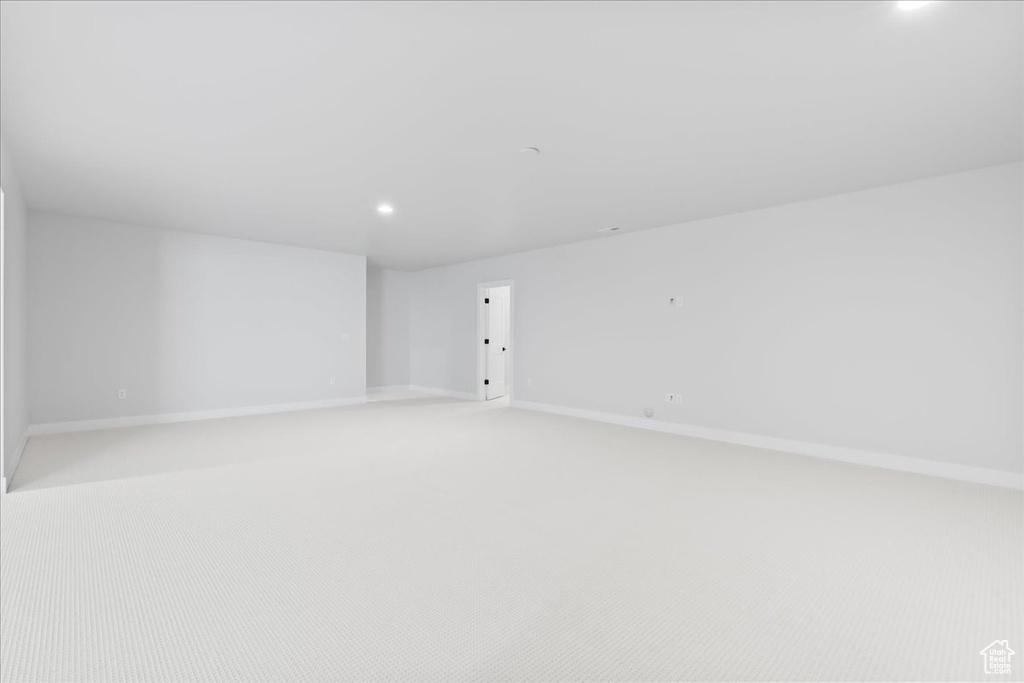 Unfurnished room featuring light carpet, recessed lighting, and baseboards