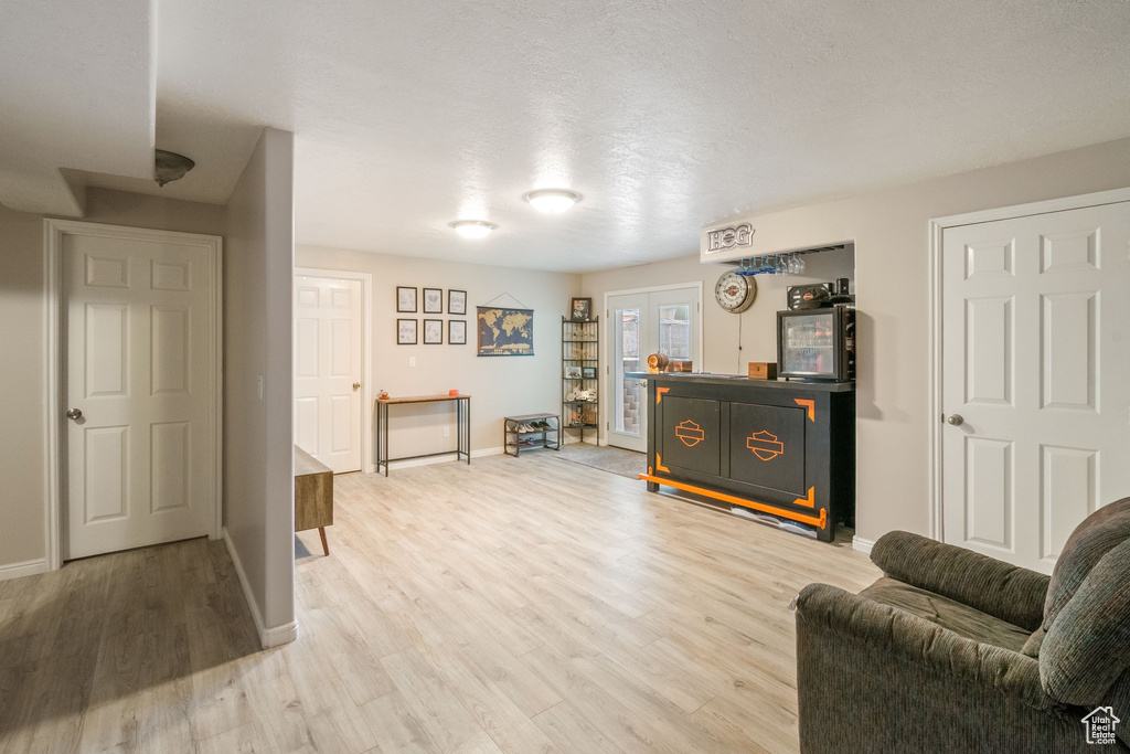 Living area featuring baseboards and wood finished floors