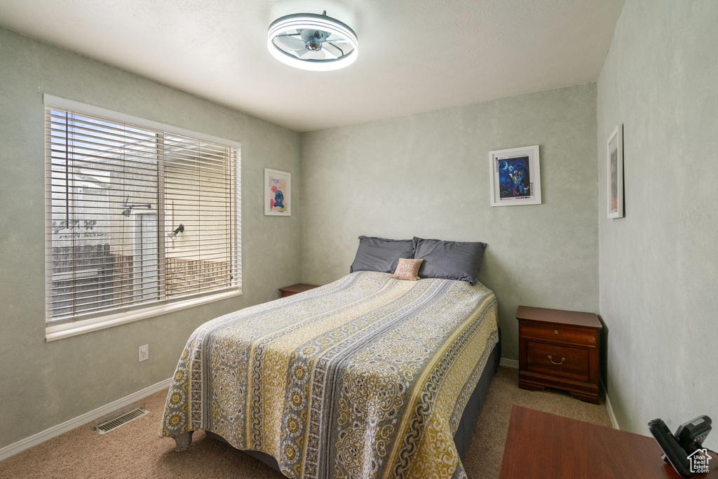 Bedroom with carpet floors and baseboards
