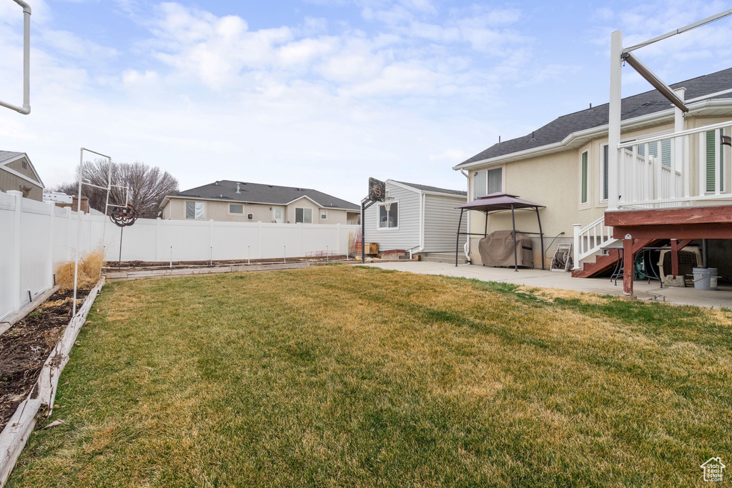 View of yard with a patio, a residential view, stairs, and a wooden deck