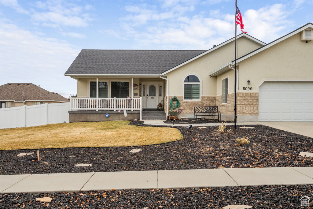 Ranch-style home featuring a porch, an attached garage, stucco siding, concrete driveway, and roof with shingles