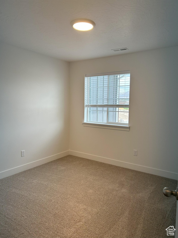 Unfurnished room with carpet and baseboards