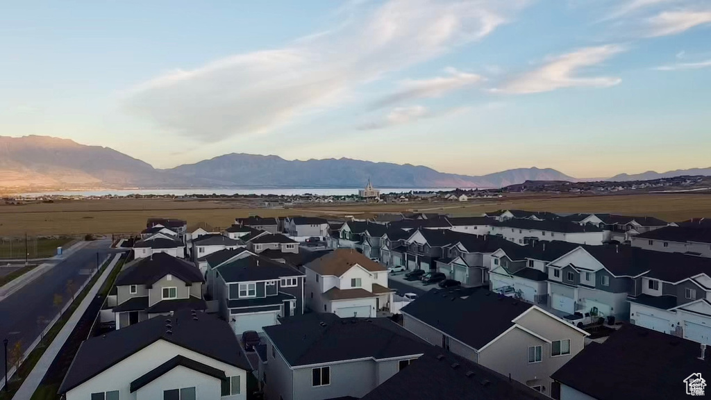View of mountain backdrop featuring nearby suburban area and a large body of water