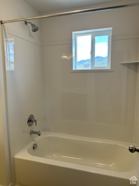 Full bath featuring plenty of natural light and tub / shower combination