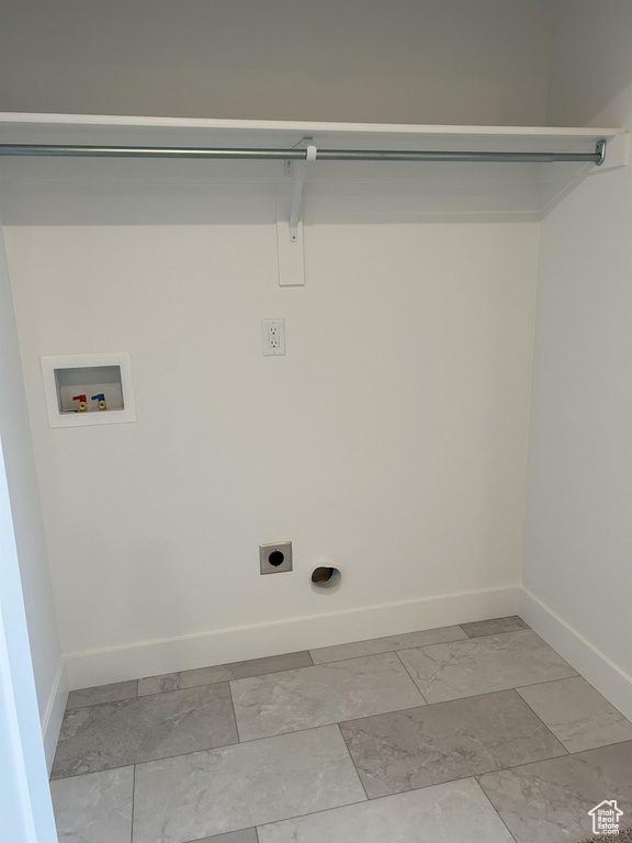 Washroom with hookup for a washing machine, light marble finish floors, baseboards, and electric dryer hookup