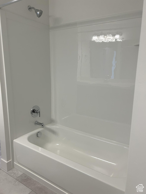 Full bathroom with tub / shower combination and tile patterned flooring