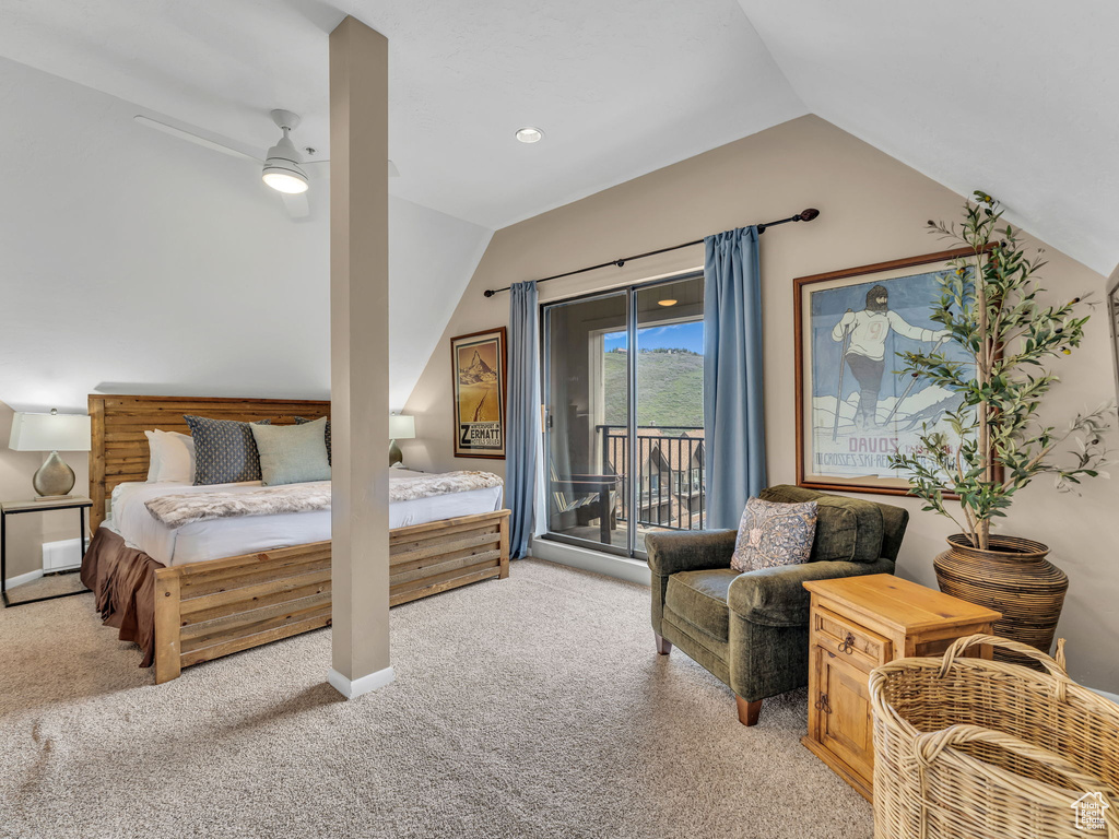 Bedroom with vaulted ceiling, access to exterior, and light carpet