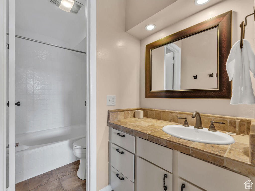 Full bathroom featuring vanity, toilet, shower / bath combination, and recessed lighting
