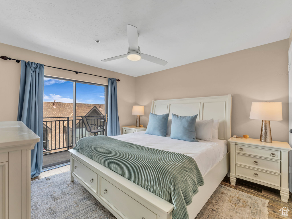 Bedroom featuring access to outside, light wood finished floors, and a ceiling fan
