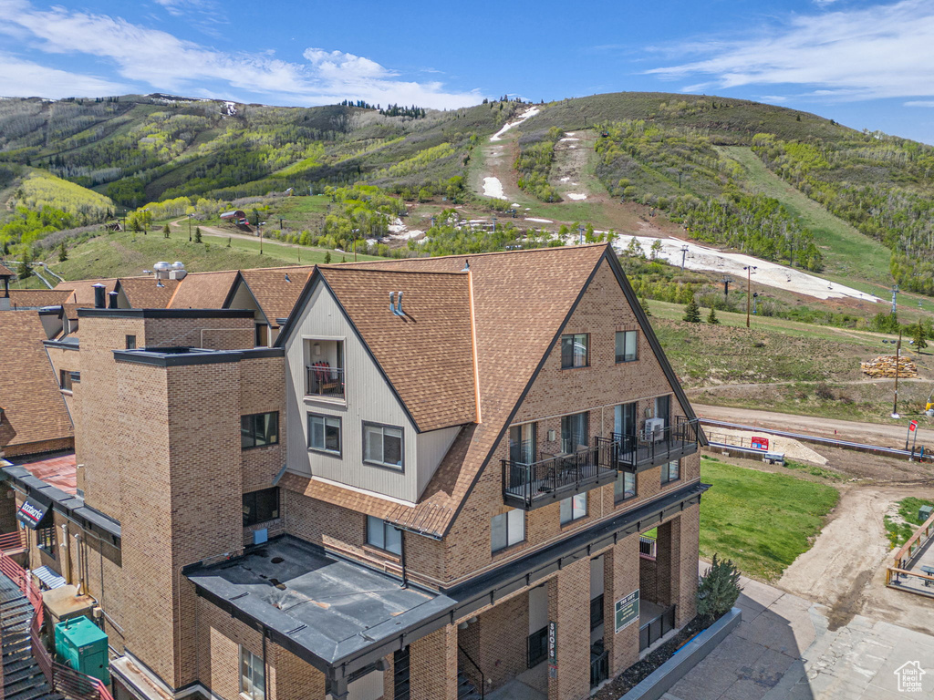 View of subject property featuring a mountainous background