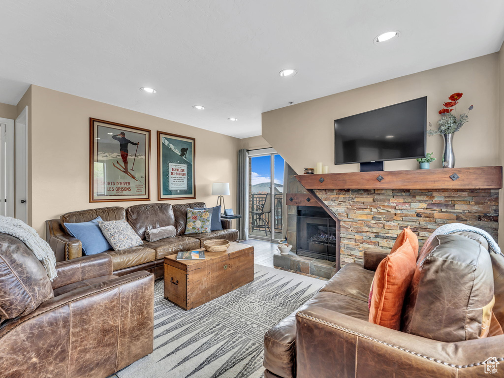 Living room featuring a glass covered fireplace and recessed lighting