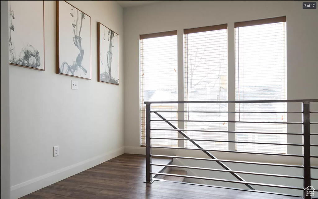 Unfurnished bedroom featuring dark wood-style floors and baseboards