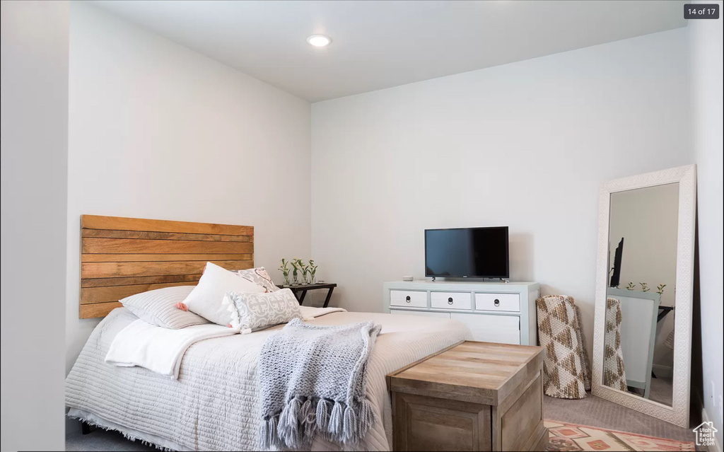 Bedroom featuring light colored carpet