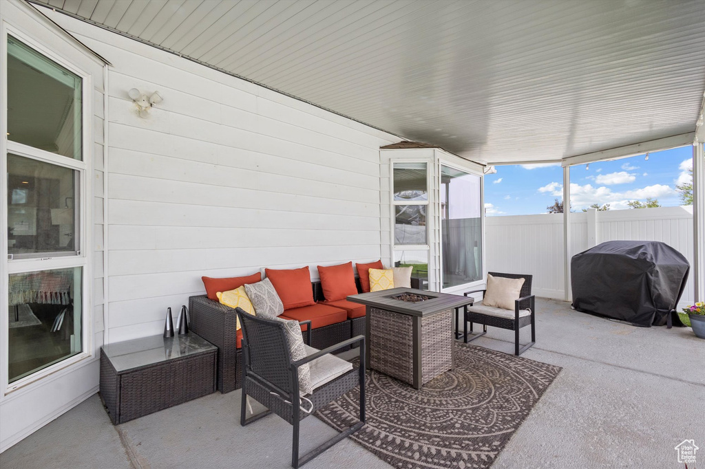 View of patio featuring grilling area and an outdoor living space with a fire pit